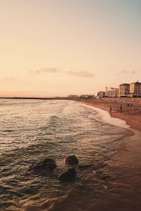 Scenic view of beach against sky during sunset