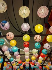 Low angle view of illuminated lanterns hanging at ceiling