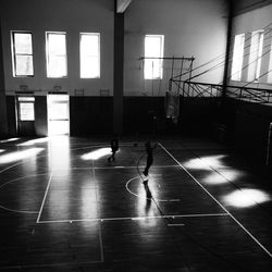 Boys practicing basketball on court