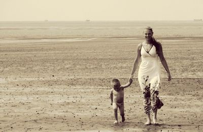 Full length of woman standing on beach