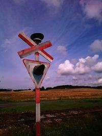 Traditional windmill on field against sky