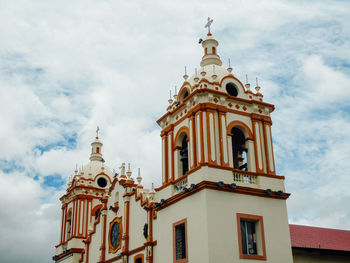 Low angle view of bell tower against sky