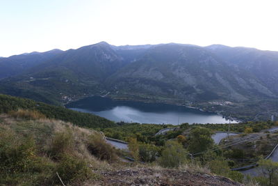 Scenic view of lake and mountains against clear sky