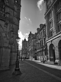 Street amidst buildings in city against sky