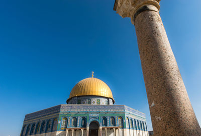 Low angle view of a building against blue sky