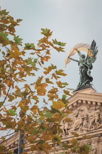 Low angle view of angel statue against sky