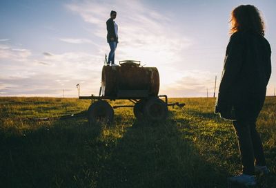 Woman standing on grassy field