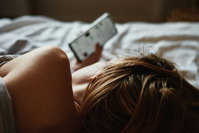 Woman using smartphone in the bed, social media, insomnia concept