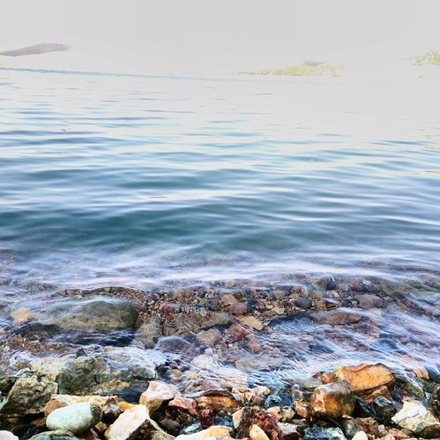 water, sea, rock - object, wave, scenics, beauty in nature, nature, tranquility, rippled, tranquil scene, stone - object, shore, surf, beach, horizon over water, day, idyllic, outdoors, motion, pebble