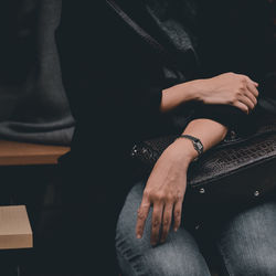 Midsection of woman sitting on seat