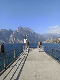 Pier over sea against blue sky