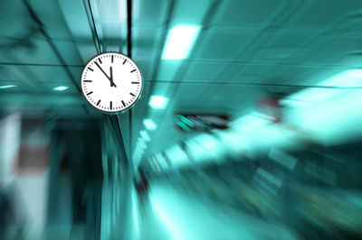 Clock at railroad station platform during night