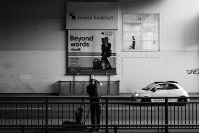 Man standing by text on wall