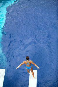 High angle view of woman standing in swimming pool