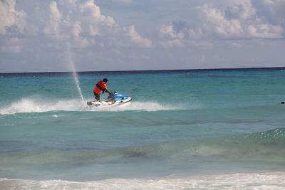 Man riding jet boat in sea