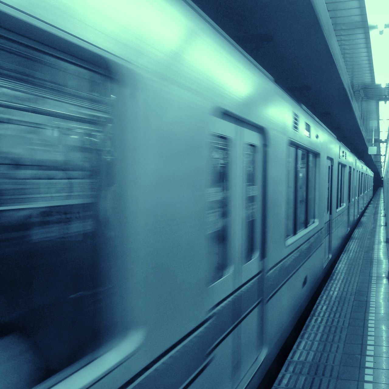 transportation, built structure, architecture, public transportation, building exterior, motion, railroad track, rail transportation, glass - material, blurred motion, mode of transport, speed, on the move, train - vehicle, city, reflection, railroad station, travel, long exposure, window