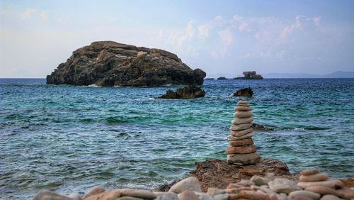 Scenic view of rocks in sea against sky