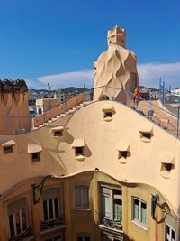 Low angle view of la pedrera's rooftop against clear blue sky