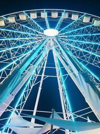 Low angle view of illuminated ferris wheel against sky