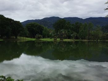 Scenic view of lake and mountains against sky