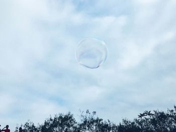 Low angle view of bubbles against sky