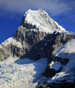 View of snowcapped mountain peak against cloudy sky