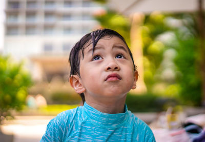 Portrait of a young boy looking up with emotion face on blurred background. emotion concept.