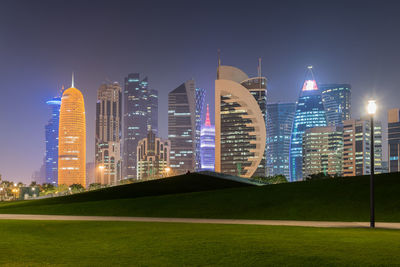 Illuminated buildings in city at night