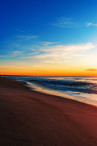 Scenic view of beach against sky during sunset