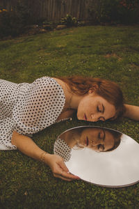 Portrait of young man lying down on land