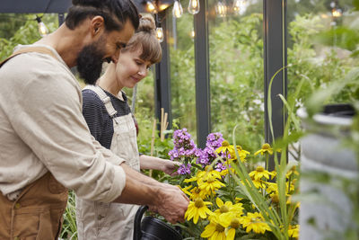 Side view of man holding flowers