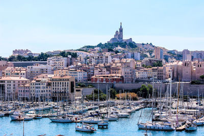 Boats in river with buildings in background