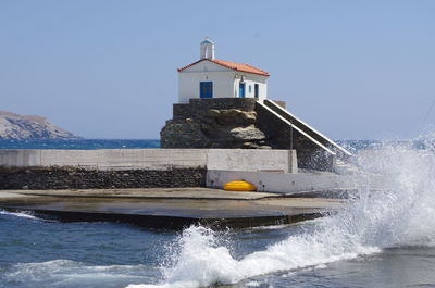 Built structure in sea against clear sky