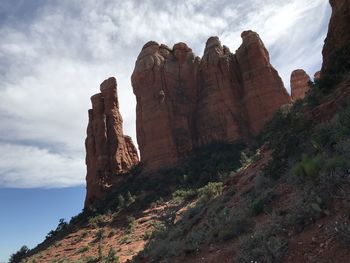 Low angle view of rock formation against sky