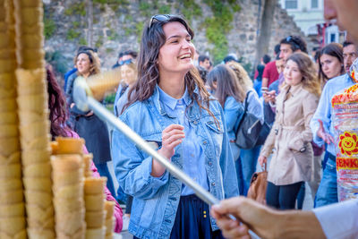 People looking at market in city