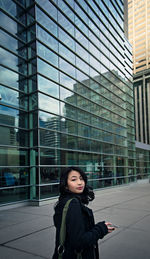 Full length of woman in city against sky