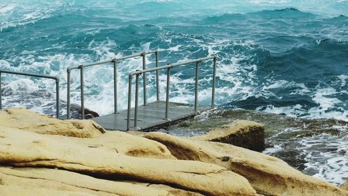 View of waves splashing on rocky coastline