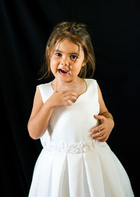 Portrait of girl in dress against black background