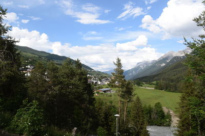 Scenic view of mountains and trees against sky