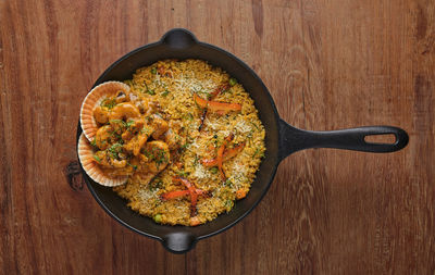 Peruvian food rice with seafood. arroz con mariscos, food served in pan, selective focus.