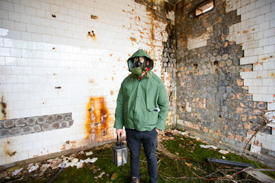 Man standing against wall