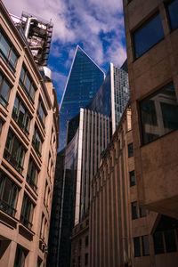 Low angle view of modern buildings against sky in city