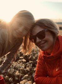 Portrait of smiling young woman against sky