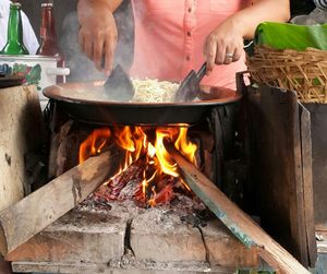 Midsection of woman preparing noodles