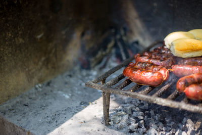 High angle view of chorizo grilling on barbecue