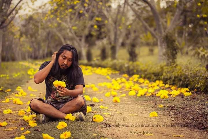 sitting, yellow, one person, full length, adult, crouching, flower, outdoors, only women, young adult, holding, day, casual clothing, people, adults only, eating, candid, lifestyles, relaxation, one woman only, women, nature, beauty, real people, one young woman only, young women, beautiful woman, tree, freshness