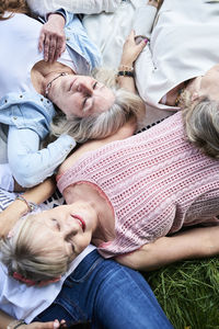 Top view of group of senior women lying in a meadow