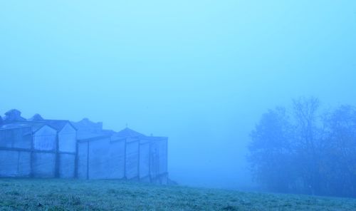 Built structure on field against clear blue sky