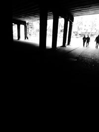 Silhouette people walking in corridor of building