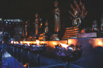 Illuminated diyas in temple at night